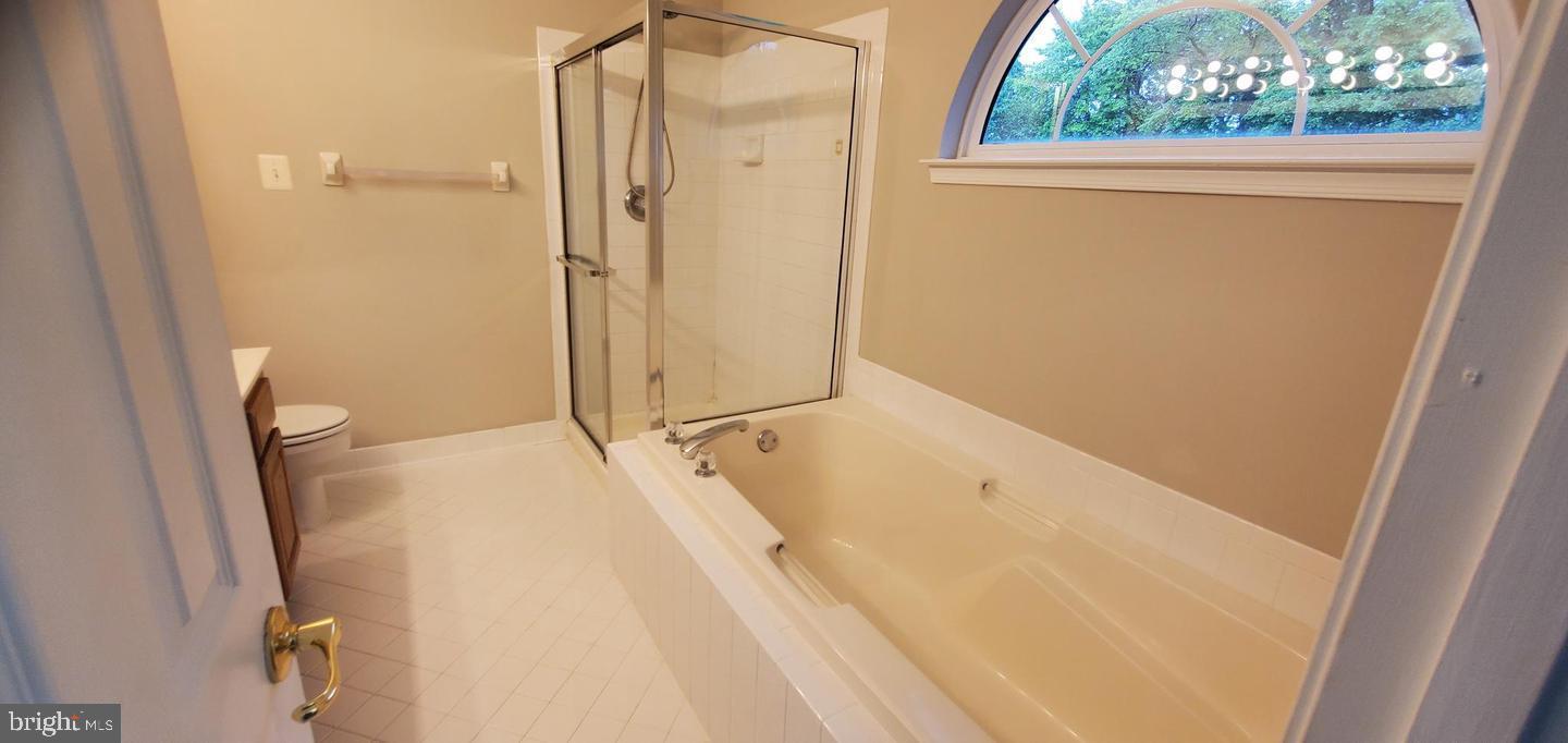 12969 Queen Chapel Road Woodbridge, VA 22193 - Photo 9 of 15 a bathroom with a tub a sink and a shower