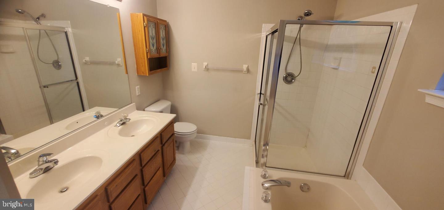 12969 Queen Chapel Road Woodbridge, VA 22193 - Photo 10 of 15 a bathroom with a sink a mirror and a shower