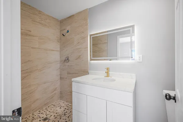 a bathroom with a sink a vanity and a mirror
