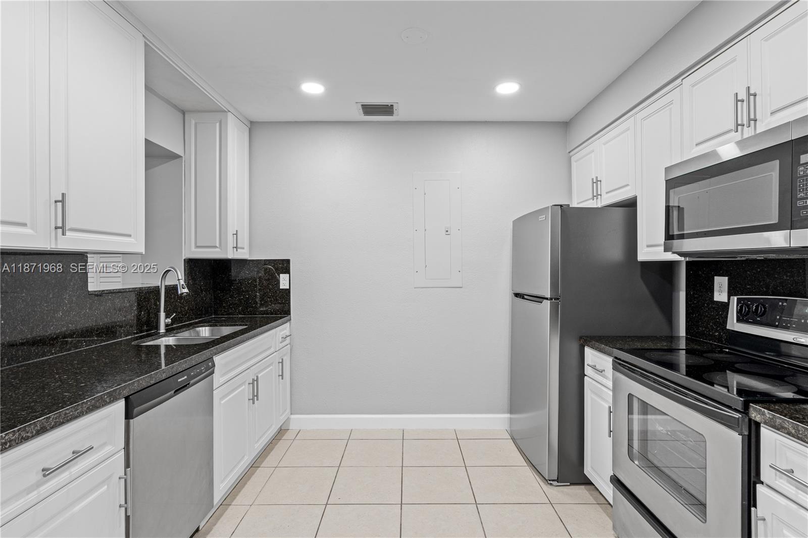 11740 Southwest 182nd Terrace Miami, FL 33177 - Photo 12 of 44 a kitchen with stainless steel appliances granite countertop a refrigerator a stove a sink and a granite counter tops
