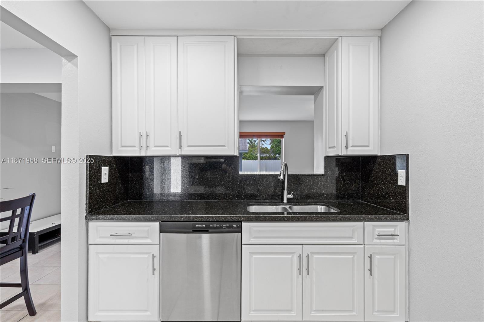 11740 Southwest 182nd Terrace Miami, FL 33177 - Photo 13 of 44 a kitchen with stainless steel appliances granite countertop a stove a sink and a microwave