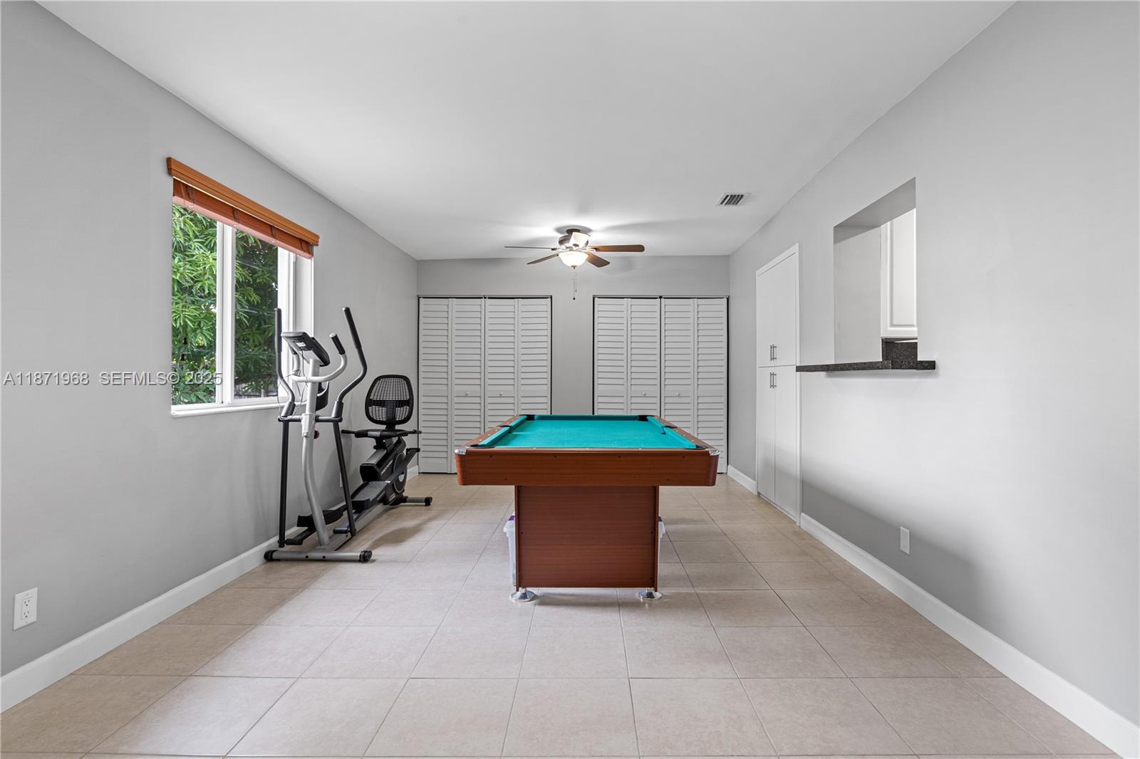 11740 Southwest 182nd Terrace Miami, FL 33177 - Photo 16 of 44 a room with a window and gym equipment