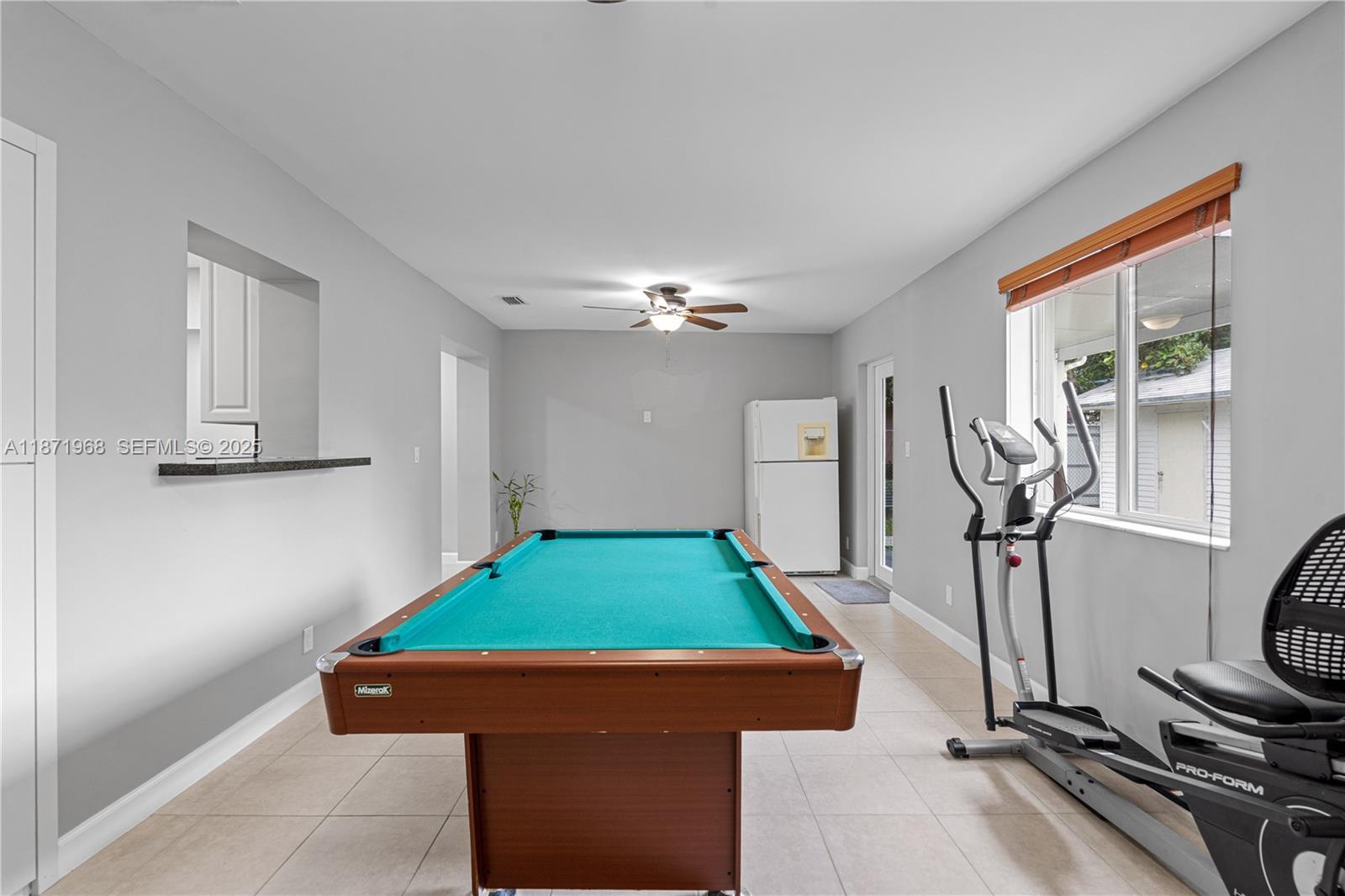 11740 Southwest 182nd Terrace Miami, FL 33177 - Photo 17 of 44 a room with pool table gym equipment mirrors and window