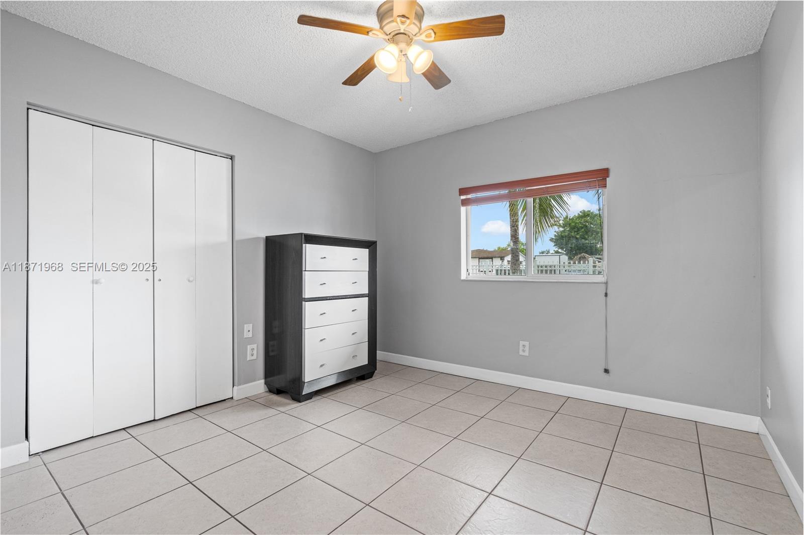 11740 Southwest 182nd Terrace Miami, FL 33177 - Photo 20 of 44 a view of an empty room with window and chandelier fan
