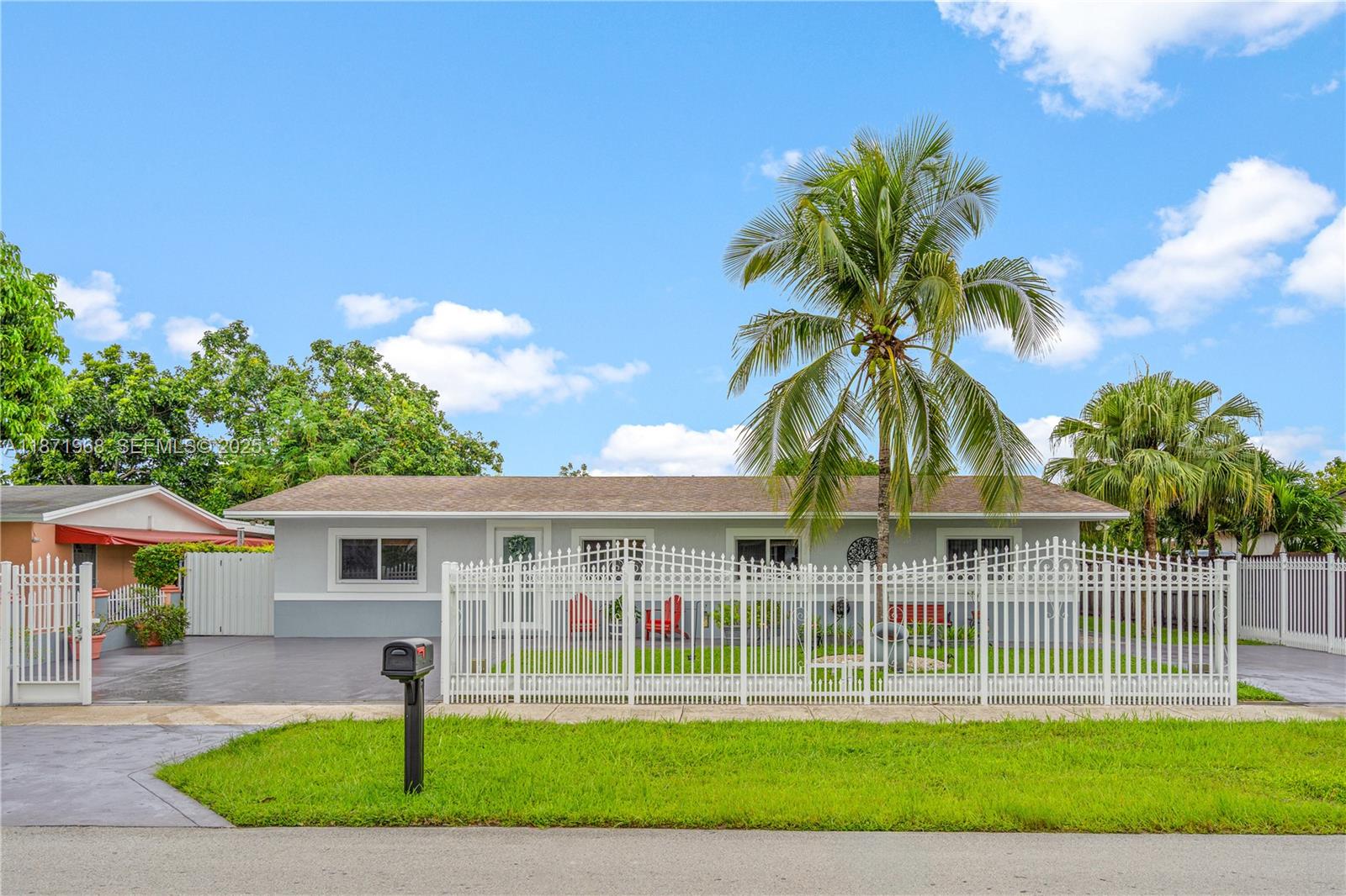 11740 Southwest 182nd Terrace Miami, FL 33177 - Photo 2 of 44 a front view of a house with a garden and plants