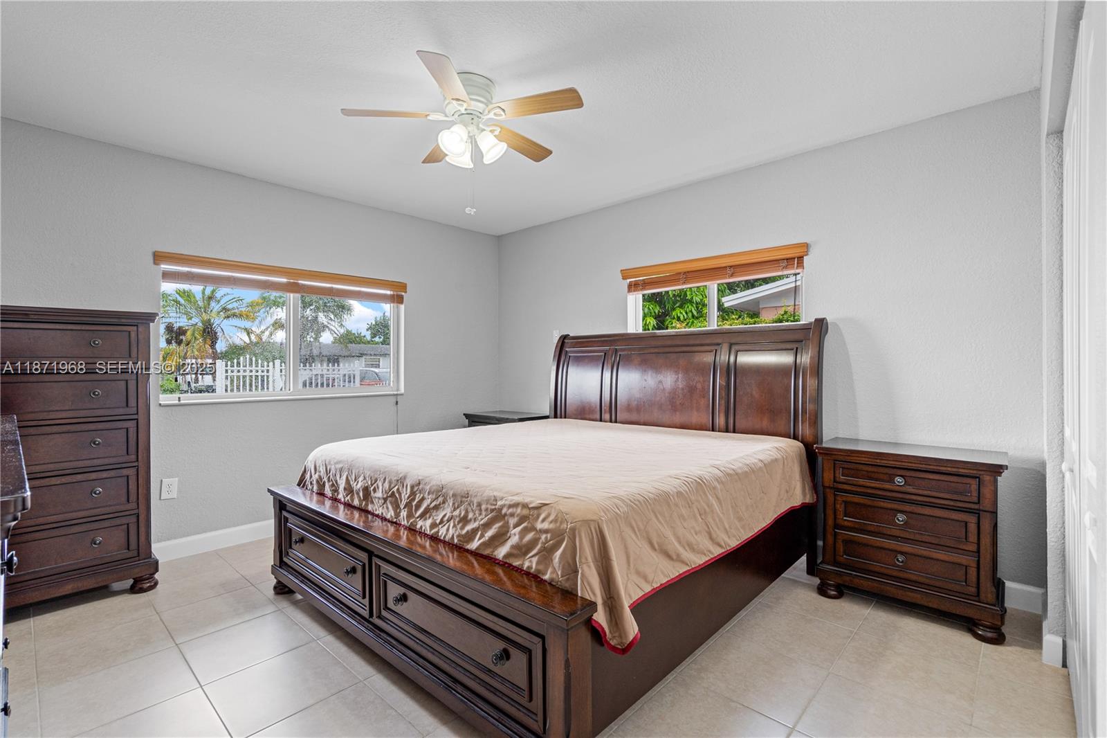 11740 Southwest 182nd Terrace Miami, FL 33177 - Photo 23 of 44 a bed sitting in a bedroom next to a window
