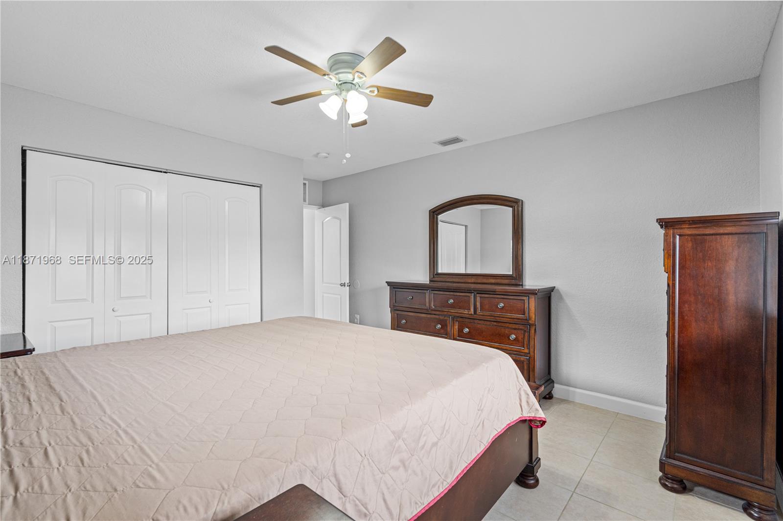 11740 Southwest 182nd Terrace Miami, FL 33177 - Photo 24 of 44 a bedroom with a bed and a chandelier