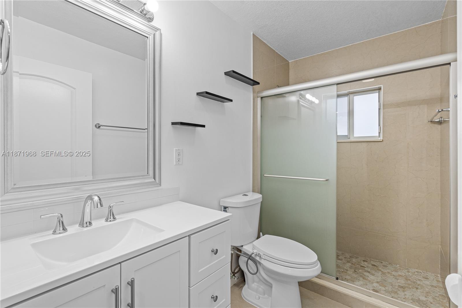 11740 Southwest 182nd Terrace Miami, FL 33177 - Photo 25 of 44 a bathroom with a sink toilet and shower