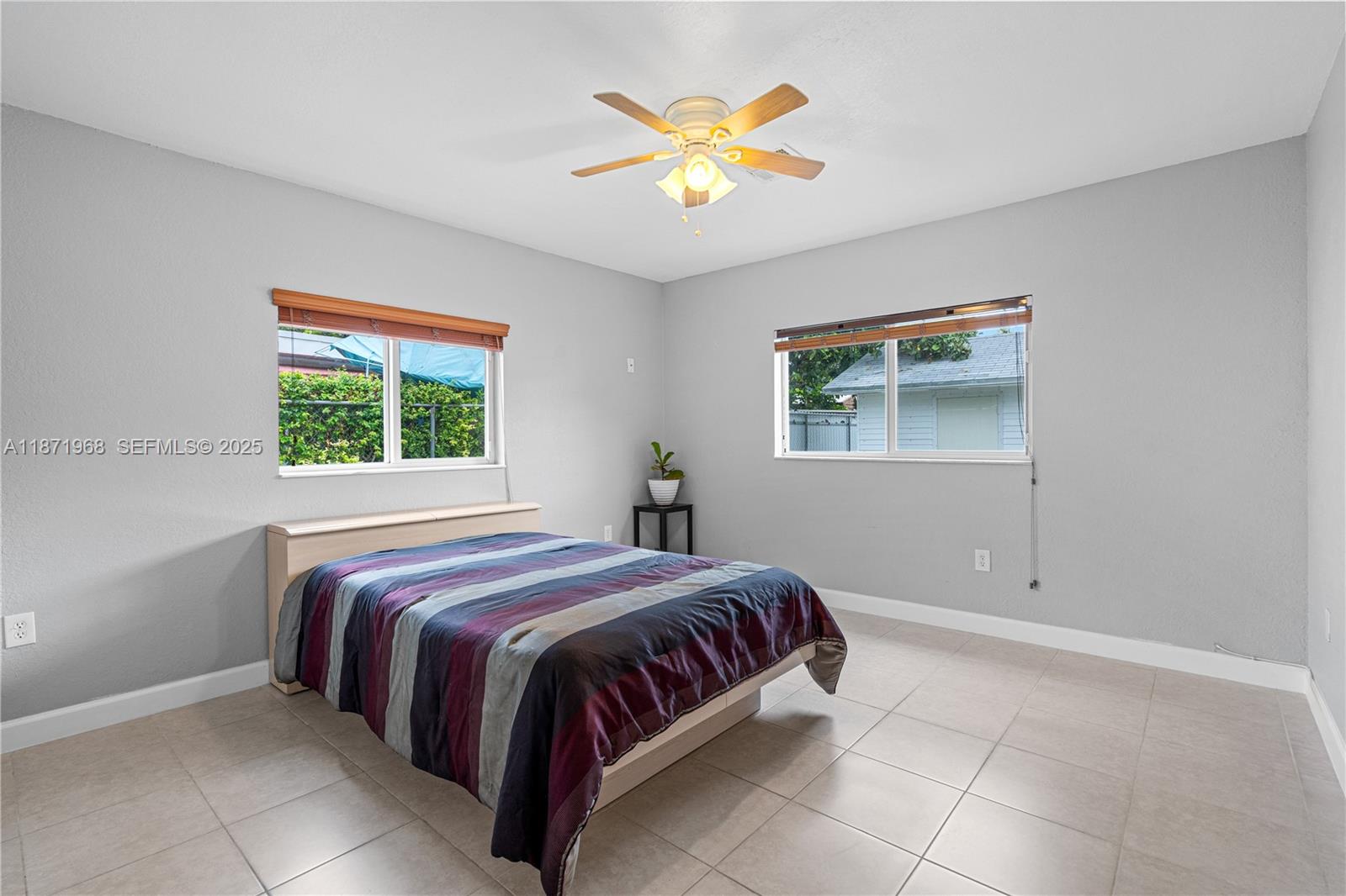 11740 Southwest 182nd Terrace Miami, FL 33177 - Photo 26 of 44 a bedroom with a bed and a window