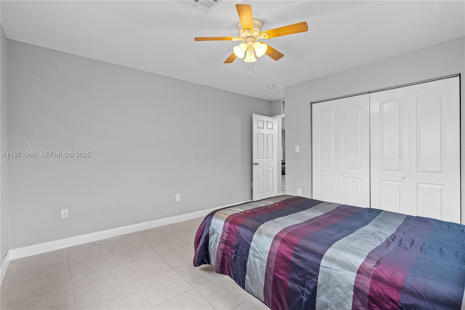11740 Southwest 182nd Terrace Miami, FL 33177 - Photo 27 of 44 a bedroom with a bed and a chandelier