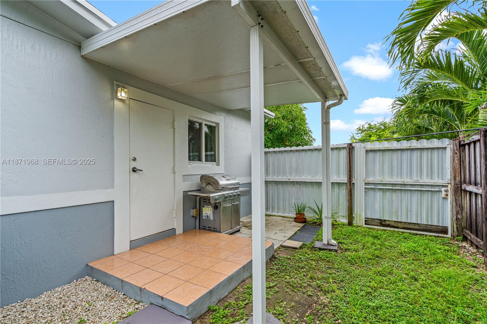 11740 Southwest 182nd Terrace Miami, FL 33177 - Photo 28 of 44 a backyard of a house with table and chairs