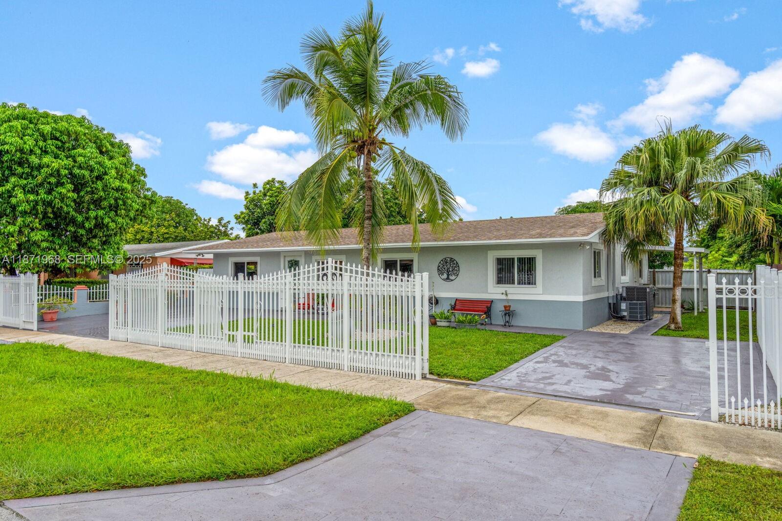 11740 Southwest 182nd Terrace Miami, FL 33177 - Photo 3 of 44 a view of a house with a yard and potted plants