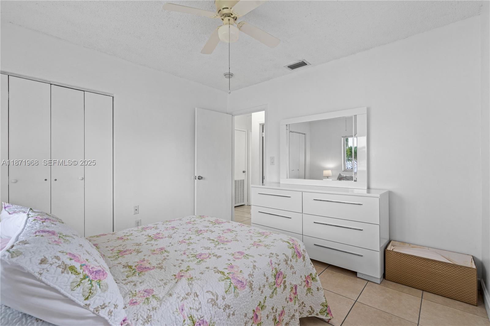 11740 Southwest 182nd Terrace Miami, FL 33177 - Photo 35 of 44 a bedroom with a bed and a mirror