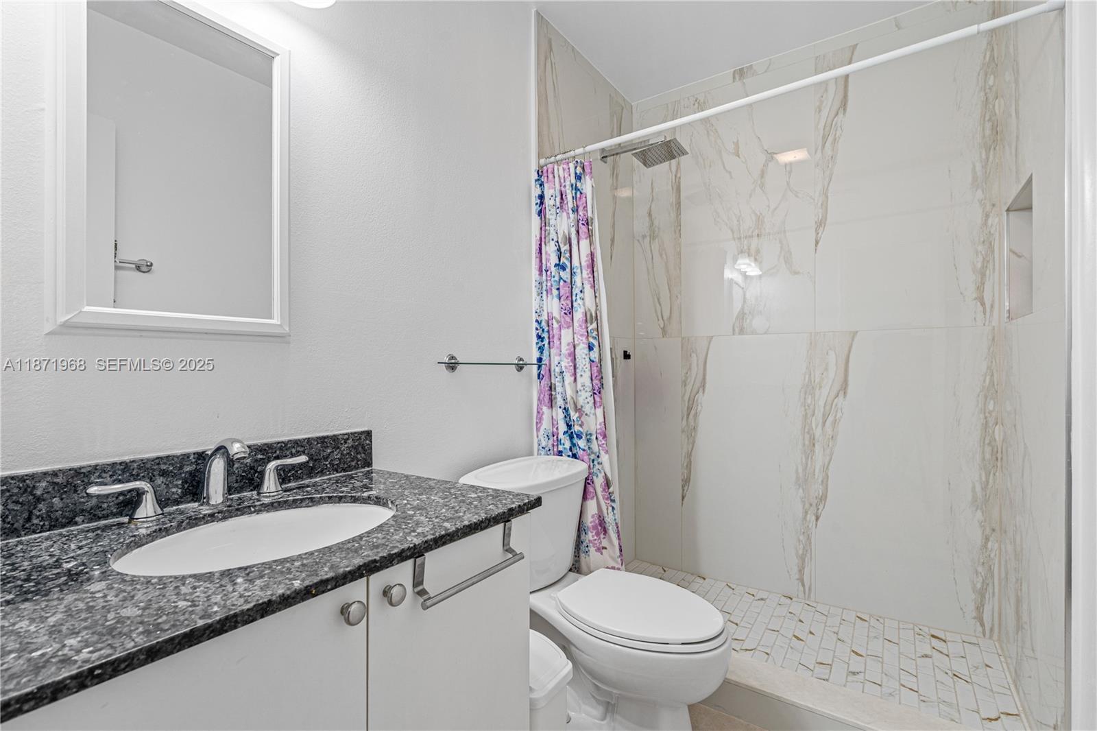 11740 Southwest 182nd Terrace Miami, FL 33177 - Photo 36 of 44 a bathroom with a granite countertop sink toilet and shower