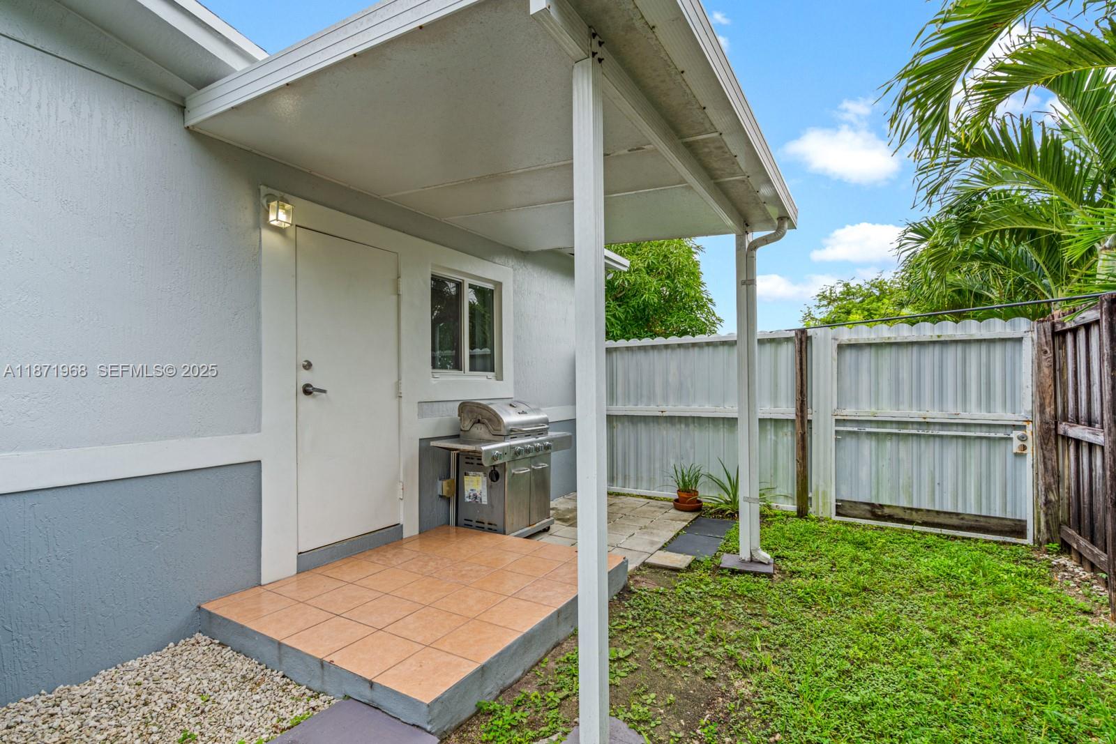 11740 Southwest 182nd Terrace Miami, FL 33177 - Photo 38 of 44 a backyard of a house with table and chairs