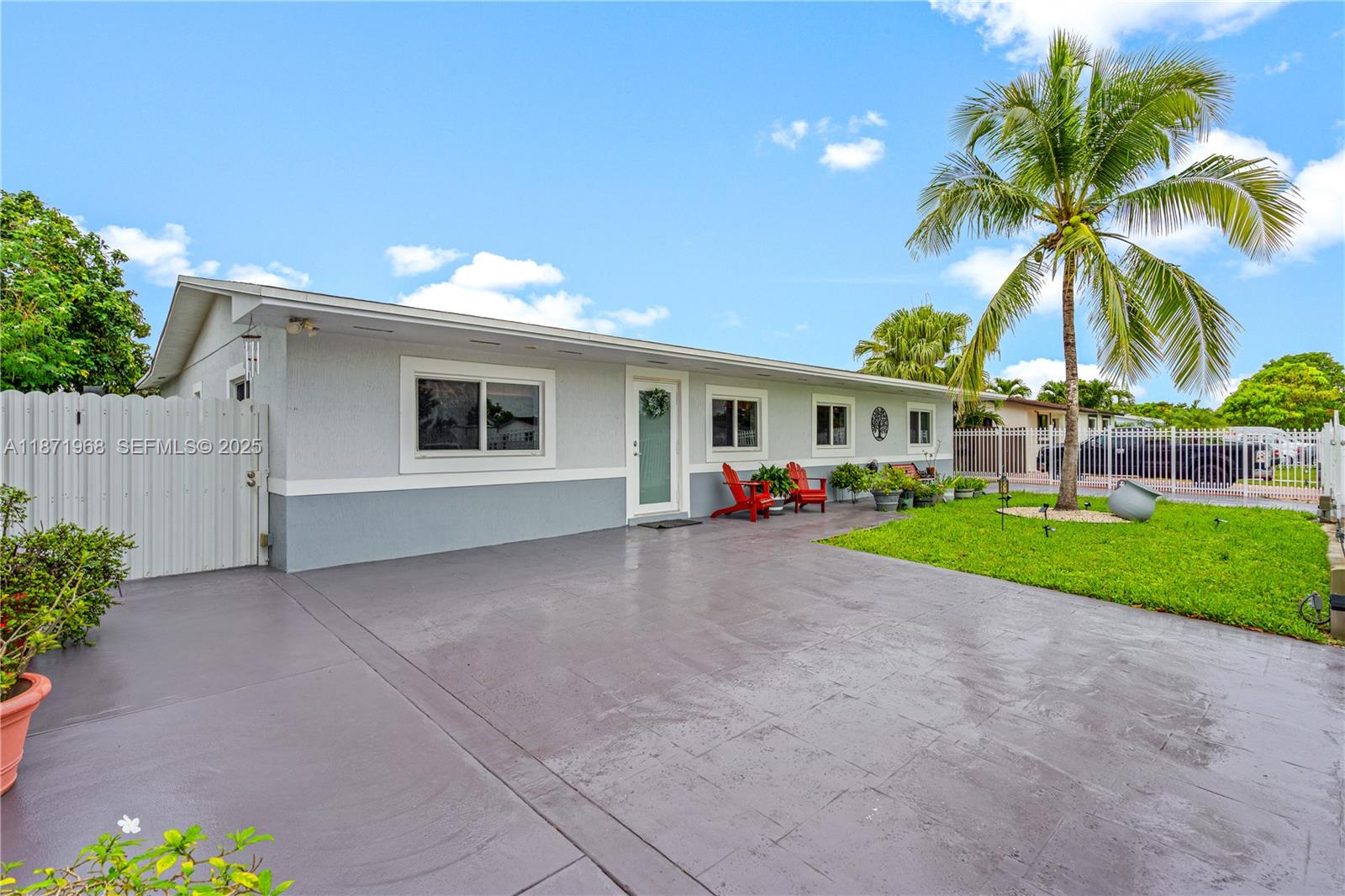 11740 Southwest 182nd Terrace Miami, FL 33177 - Photo 4 of 44 a view of a house with a yard and palm trees