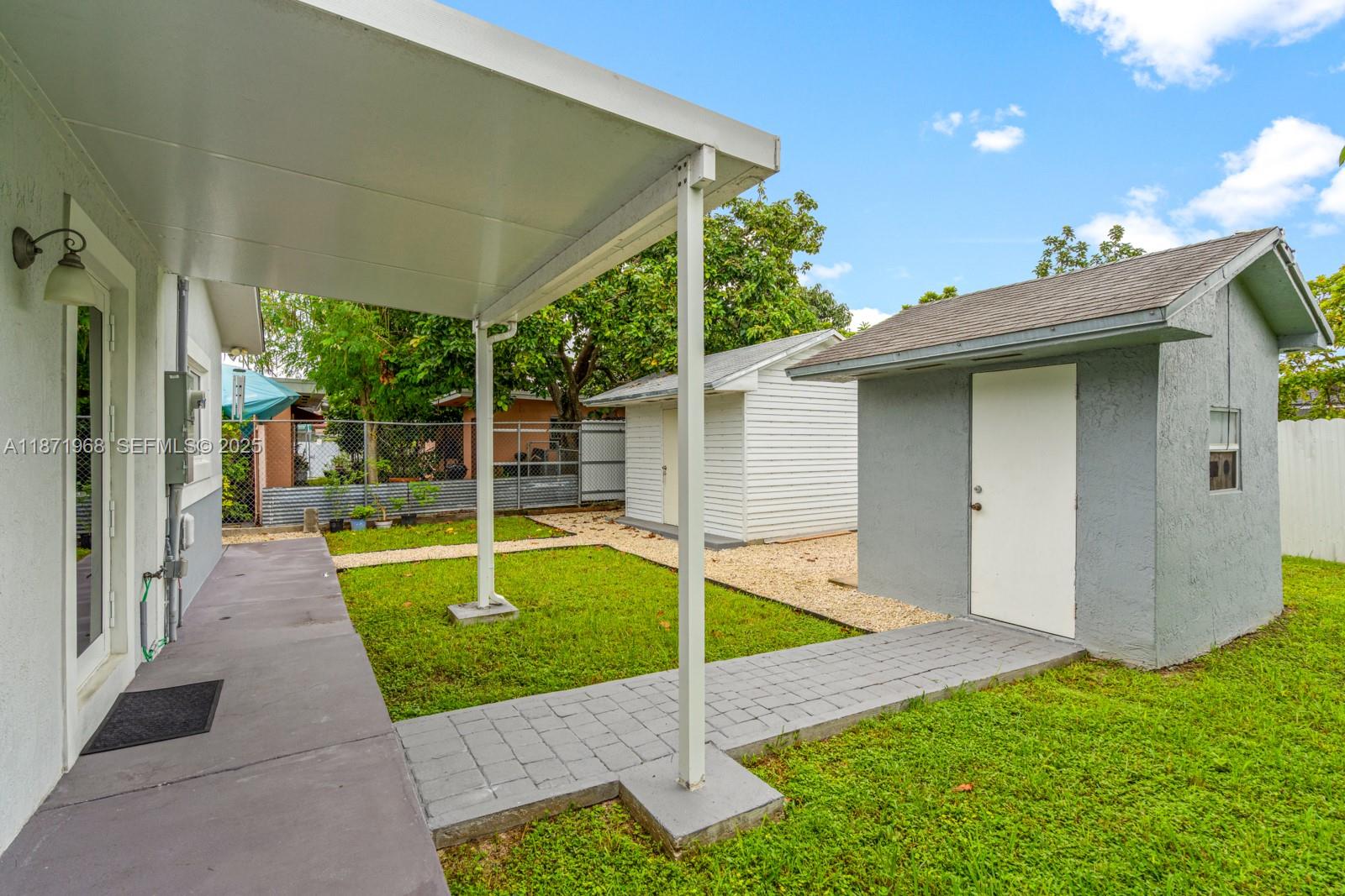 11740 Southwest 182nd Terrace Miami, FL 33177 - Photo 41 of 44 a view of a house with a yard