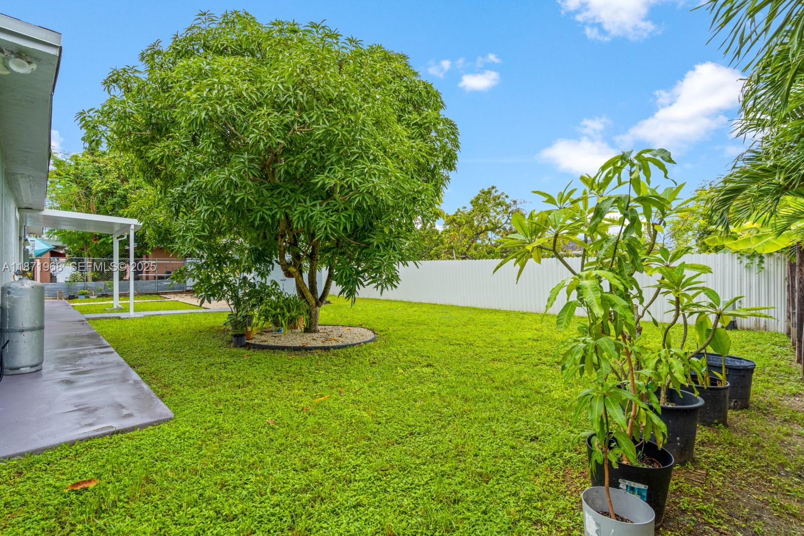 11740 Southwest 182nd Terrace Miami, FL 33177 - Photo 42 of 44 a view of a garden with a fountain