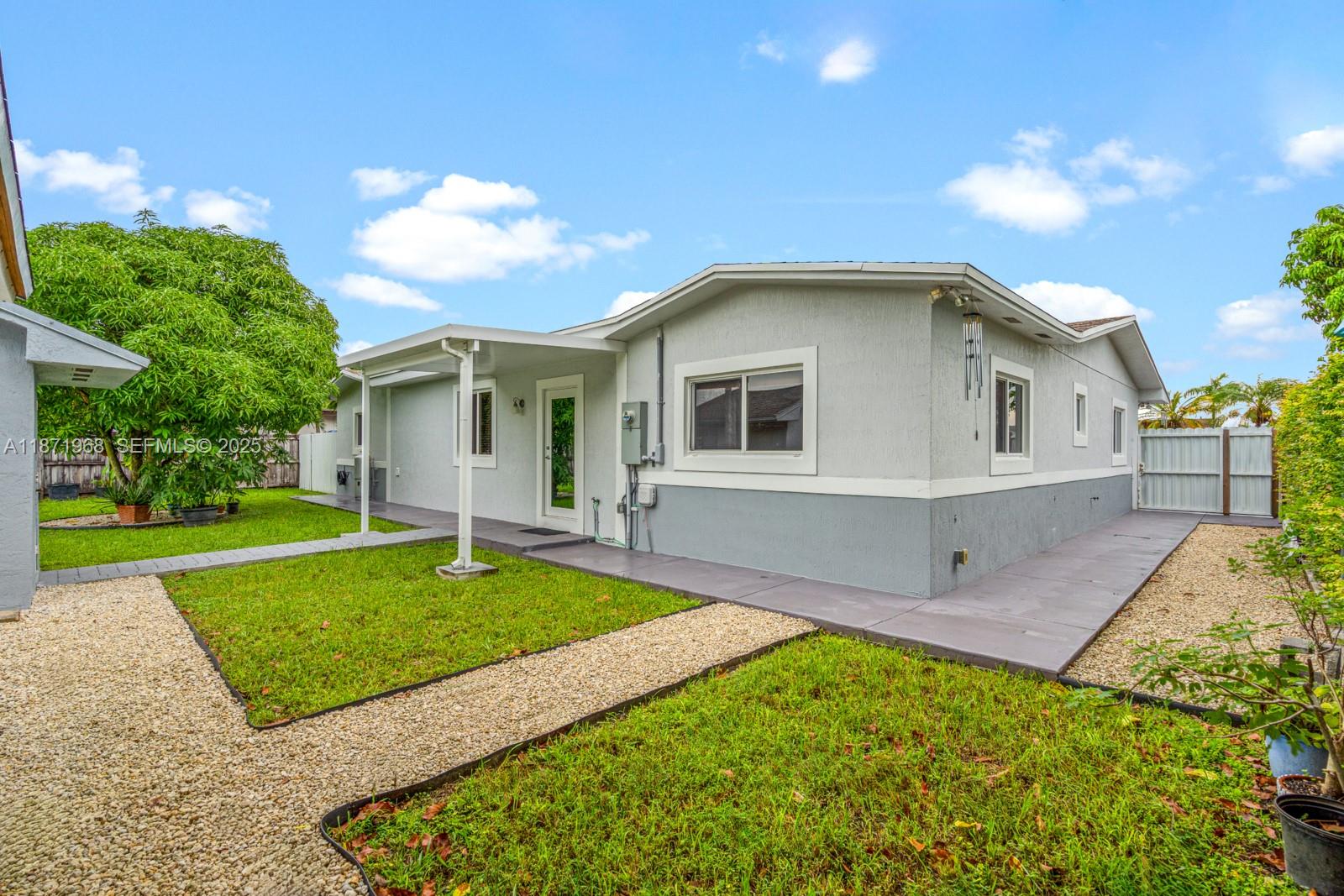 11740 Southwest 182nd Terrace Miami, FL 33177 - Photo 44 of 44 a front view of a house with a yard
