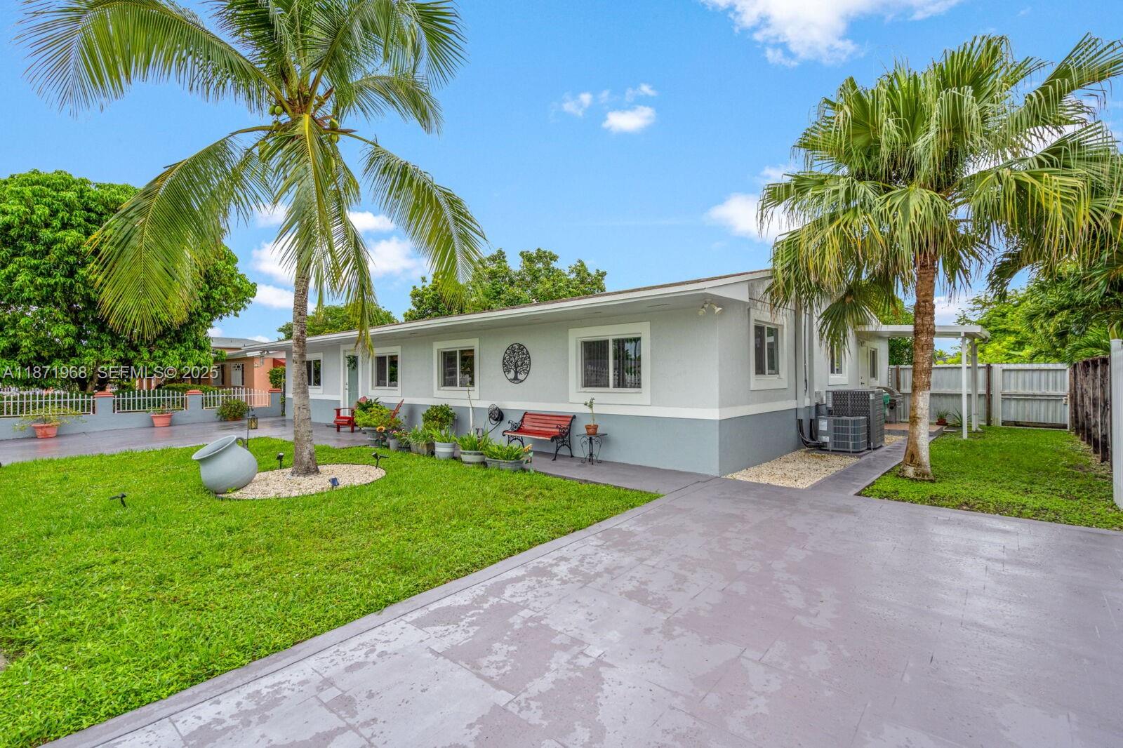 11740 Southwest 182nd Terrace Miami, FL 33177 - Photo 5 of 44 a front view of house with yard and green space