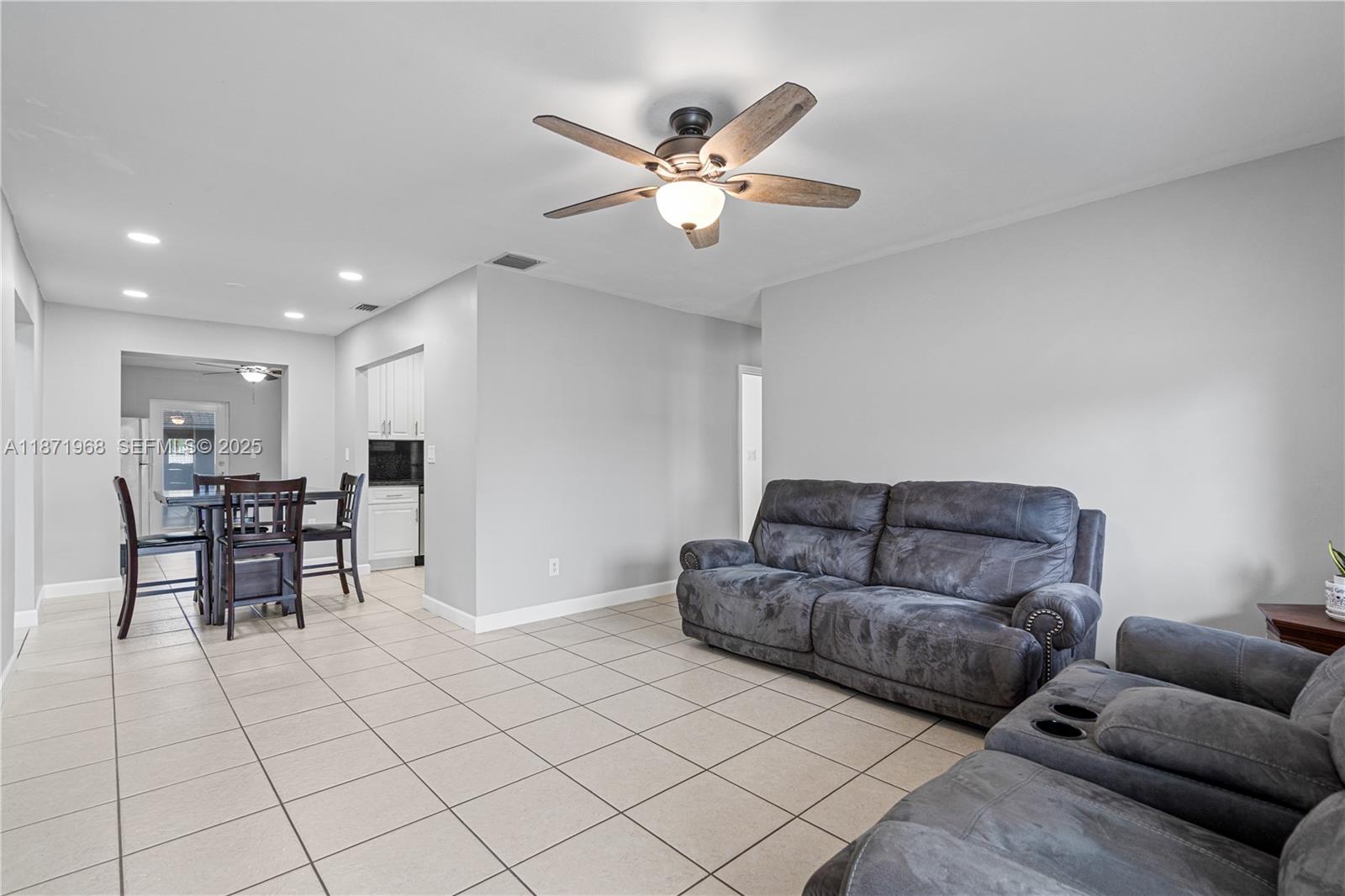 11740 Southwest 182nd Terrace Miami, FL 33177 - Photo 6 of 44 a living room with furniture and kitchen view