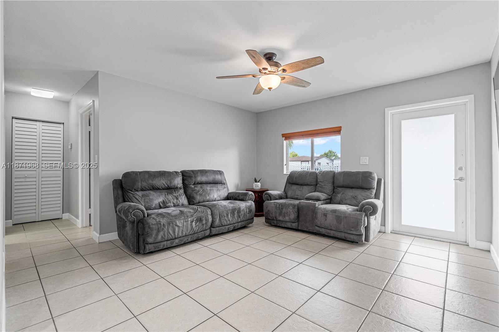 11740 Southwest 182nd Terrace Miami, FL 33177 - Photo 7 of 44 a living room with furniture and a ceiling fan