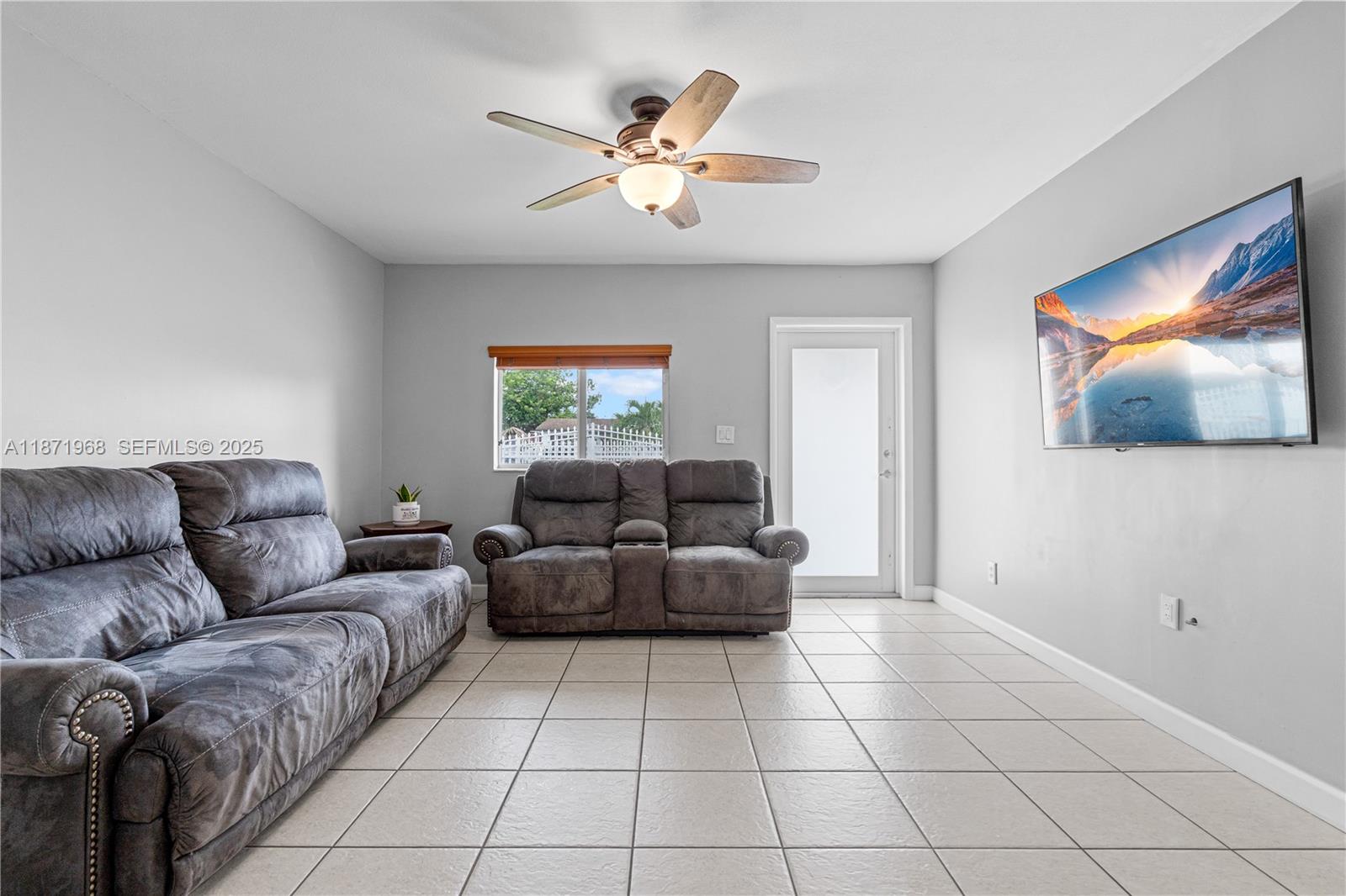 11740 Southwest 182nd Terrace Miami, FL 33177 - Photo 8 of 44 a living room with couches and a flat screen tv