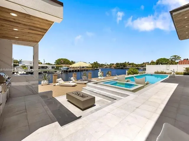 a roof deck with table and chairs a barbeque