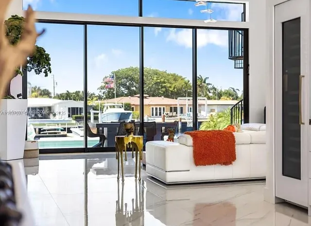 a living room with furniture and a floor to ceiling window