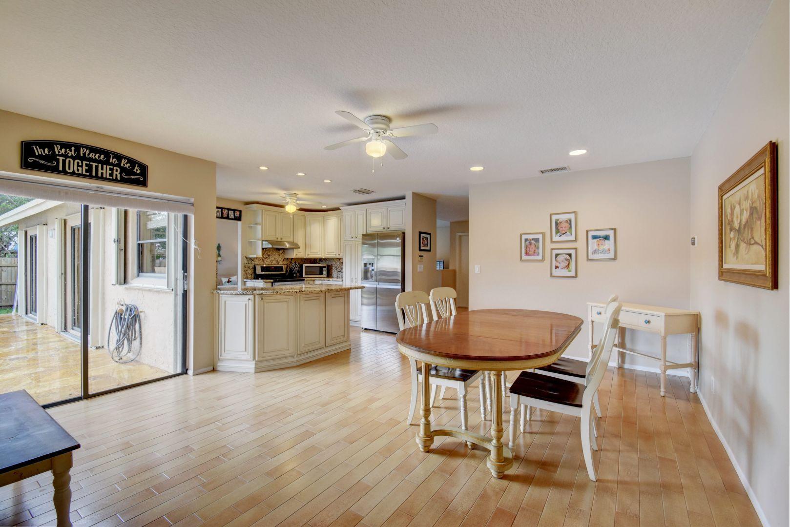 9525 Denver Court Boca Raton, FL 33434 - Photo 13 of 26 a living room with furniture a refrigerator and kitchen view