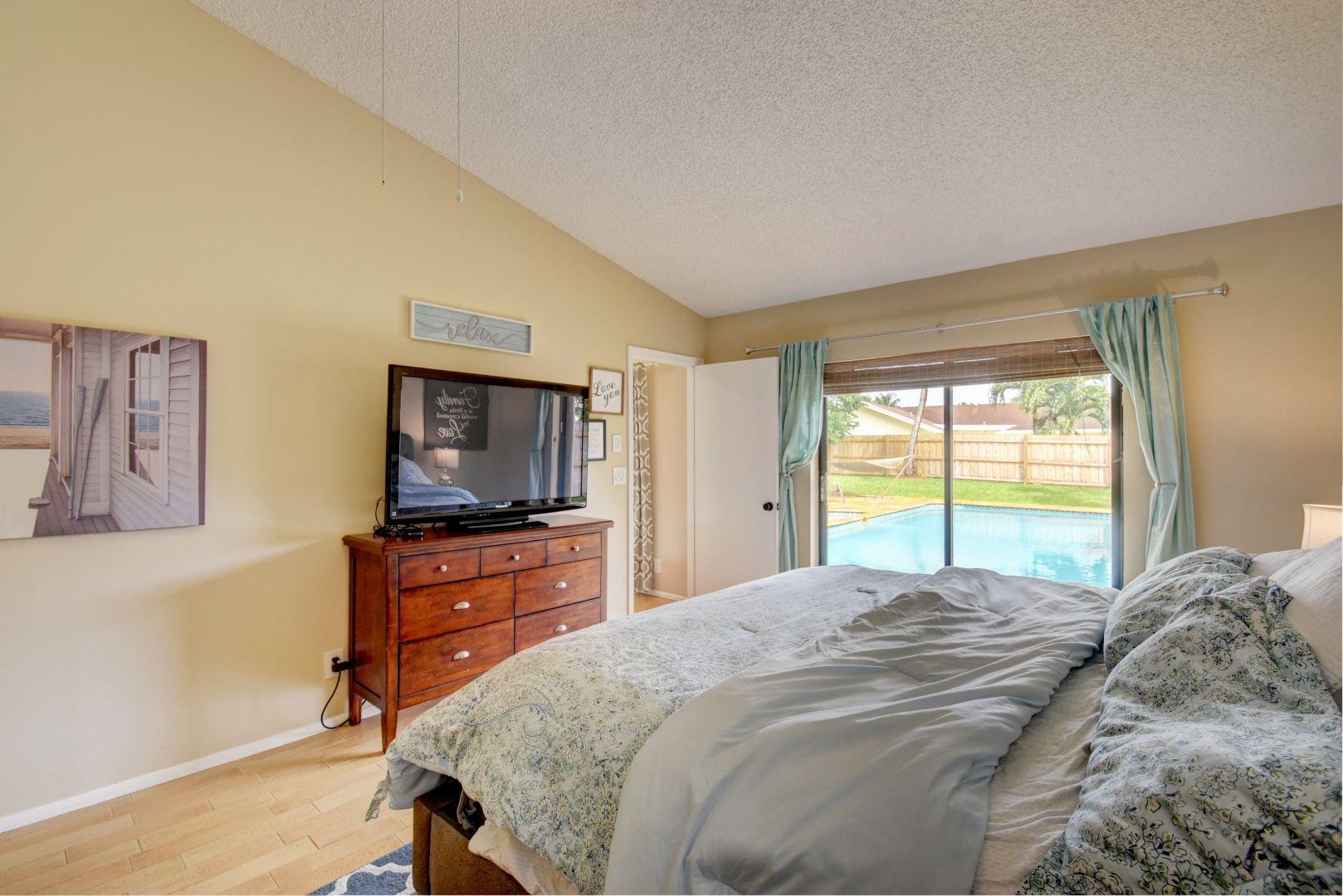 9525 Denver Court Boca Raton, FL 33434 - Photo 15 of 26 a bedroom with a bed and a flat screen tv