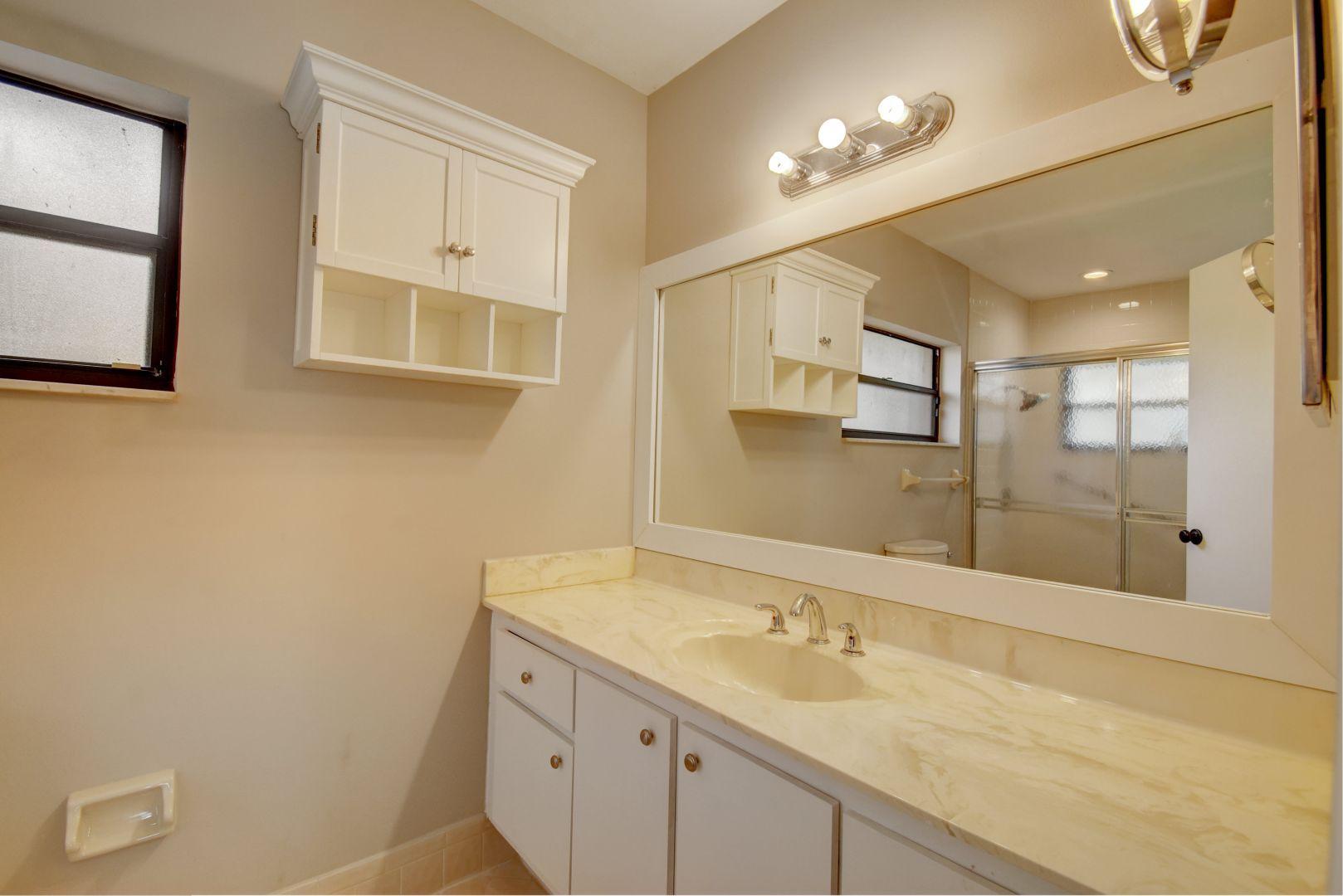 9525 Denver Court Boca Raton, FL 33434 - Photo 17 of 26 a bathroom with a granite countertop sink mirror and double