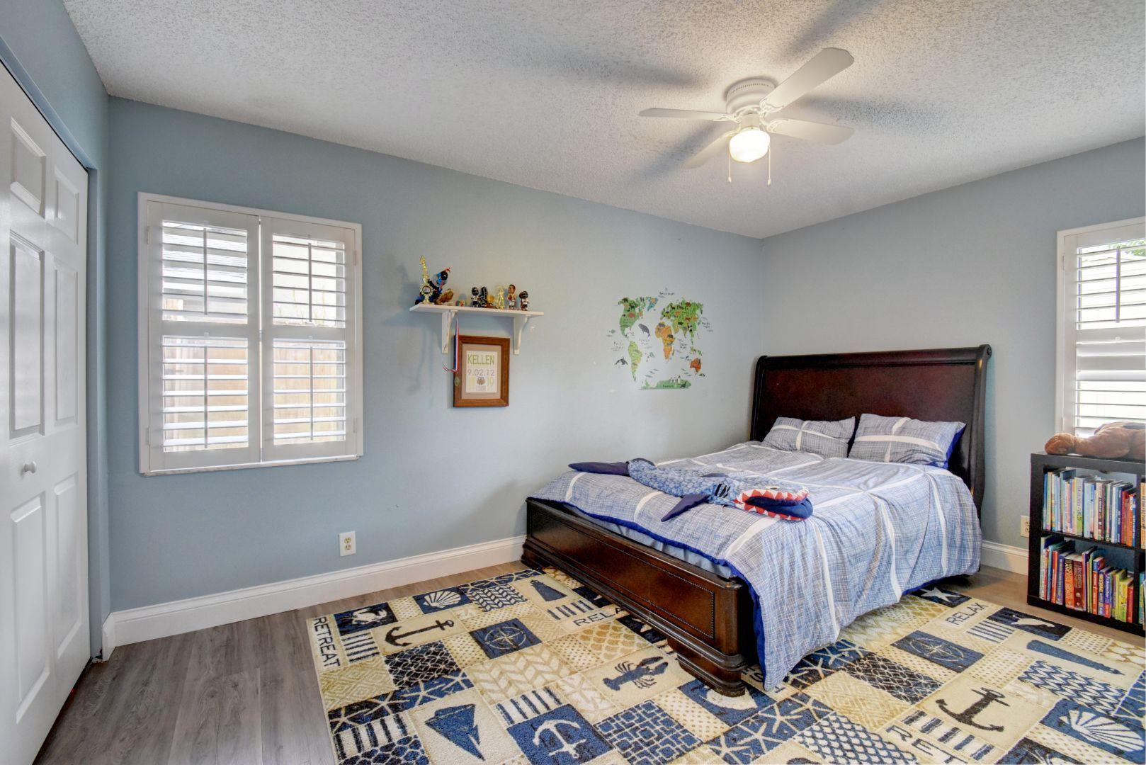 9525 Denver Court Boca Raton, FL 33434 - Photo 19 of 26 a bedroom with a bed and a chandelier