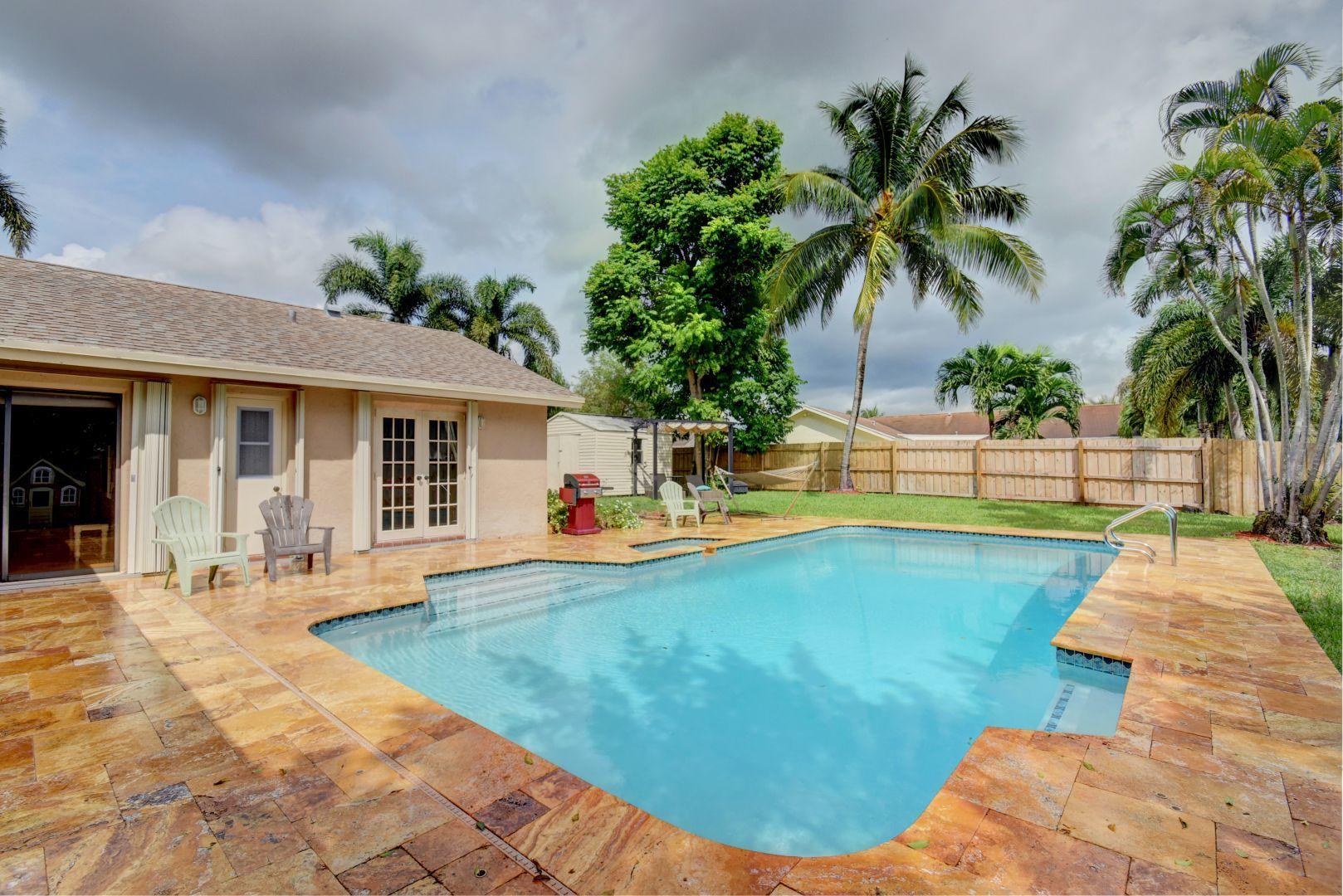 9525 Denver Court Boca Raton, FL 33434 - Photo 23 of 26 a swimming pool with outdoor seating and yard