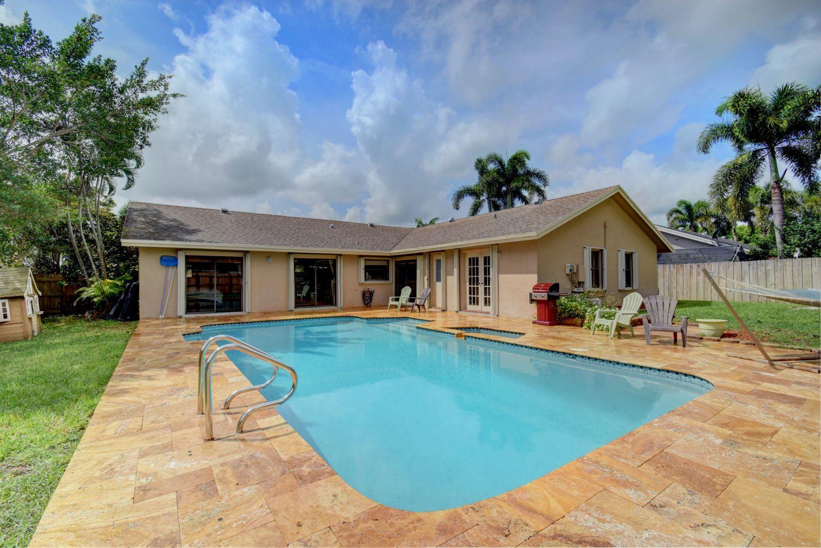 9525 Denver Court Boca Raton, FL 33434 - Photo 24 of 26 a front view of house with yard and outdoor seating