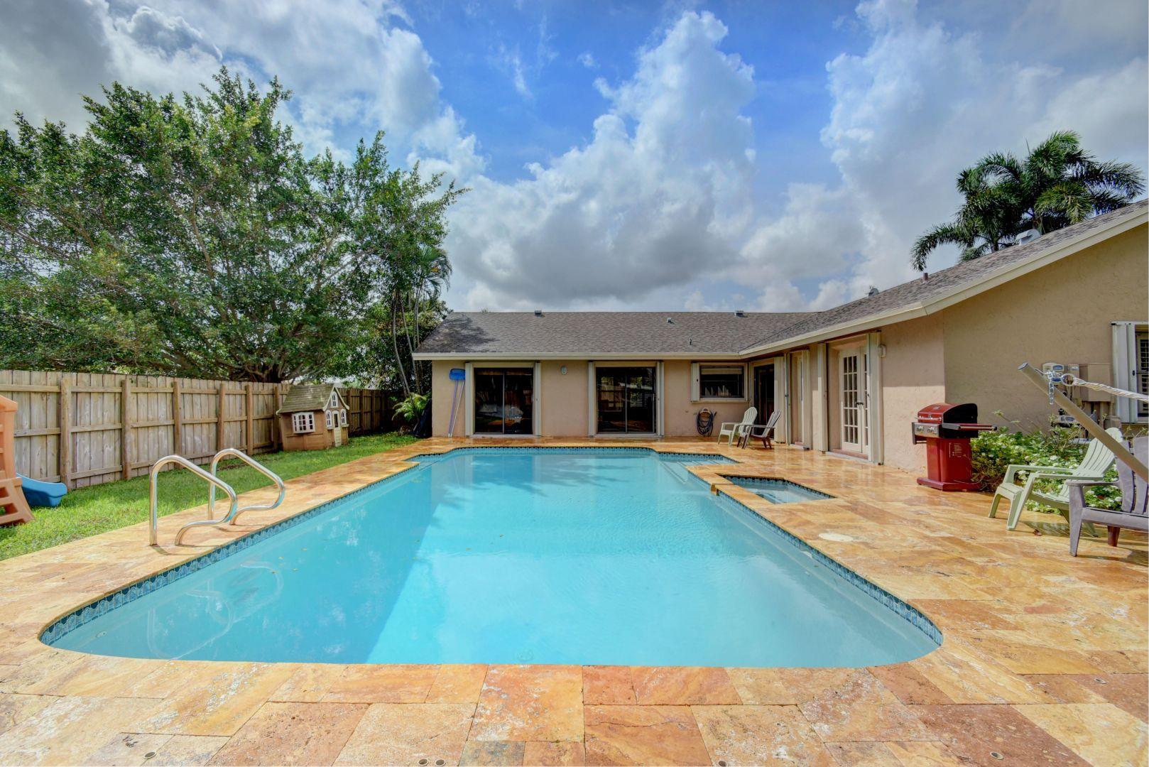 9525 Denver Court Boca Raton, FL 33434 - Photo 25 of 26 a view of a house with swimming pool and sitting area