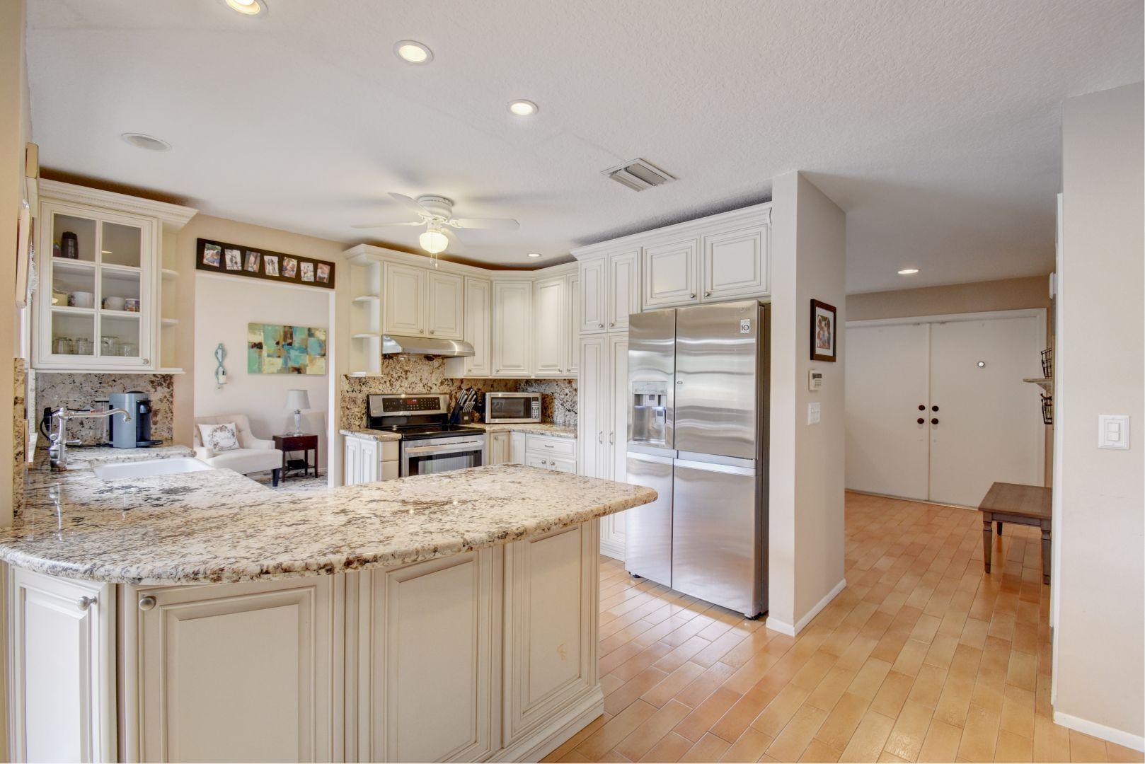 9525 Denver Court Boca Raton, FL 33434 - Photo 8 of 26 a kitchen with granite countertop a refrigerator and a sink