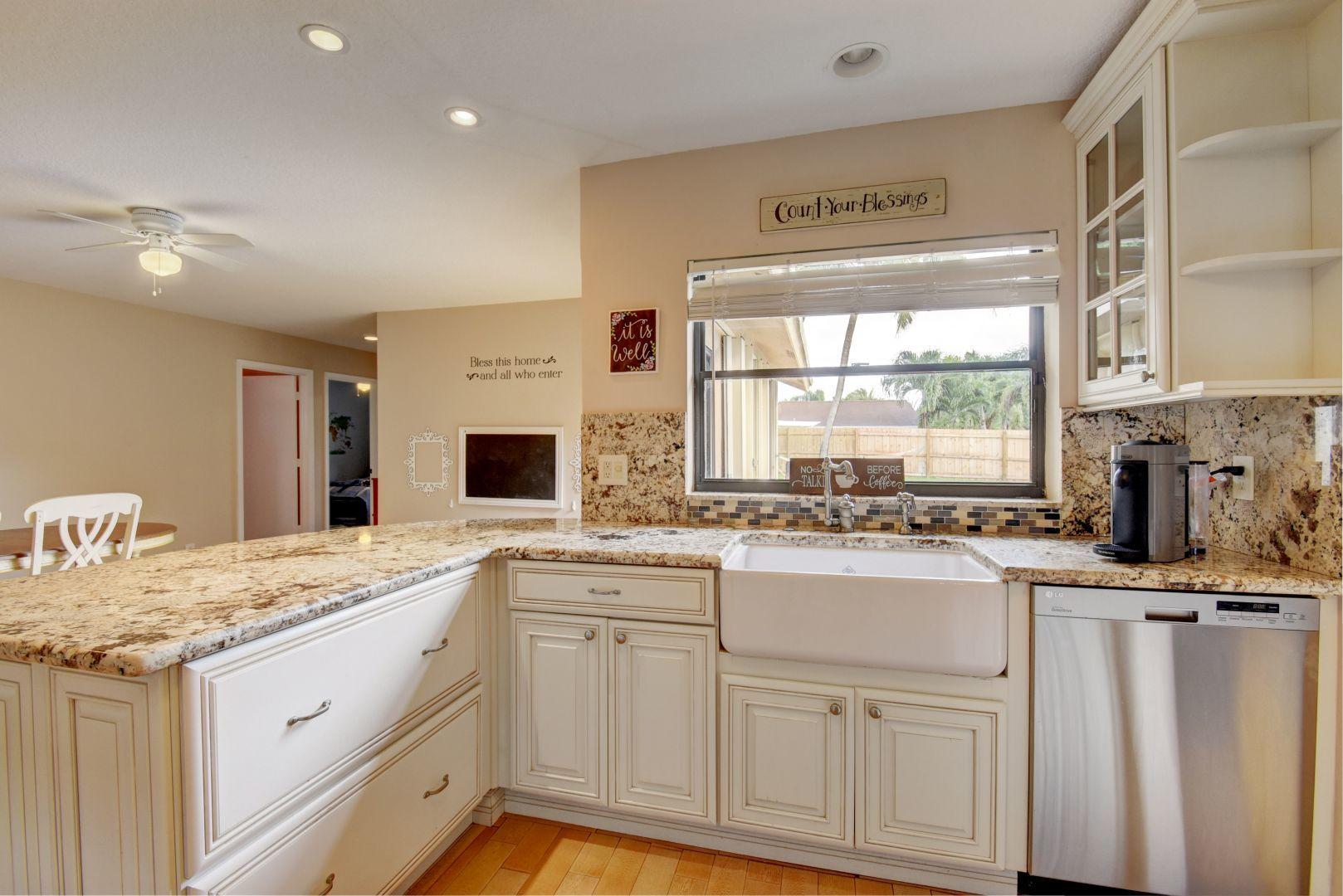9525 Denver Court Boca Raton, FL 33434 - Photo 9 of 26 a kitchen with granite countertop a sink and white cabinets