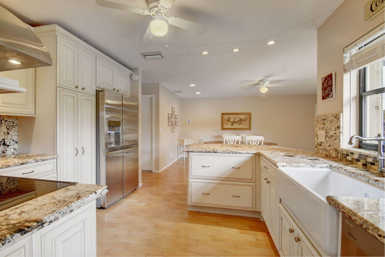9525 Denver Court Boca Raton, FL 33434 - Photo 10 of 26 a kitchen with a stove a sink and a refrigerator