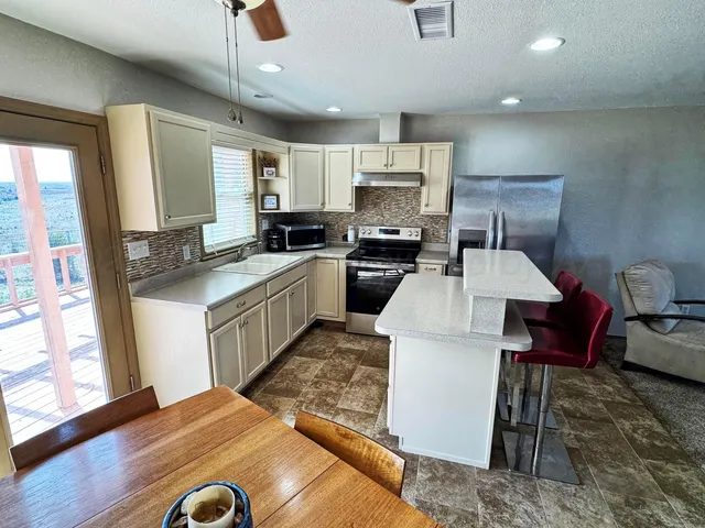 a kitchen with a stove a refrigerator and a sink