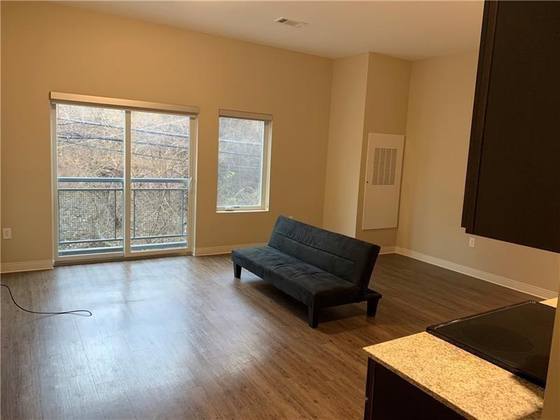 1655 Fifth Avenue, Unit 717 Pittsburgh, PA 15219 - Photo 16 of 16 a living room with furniture and a window