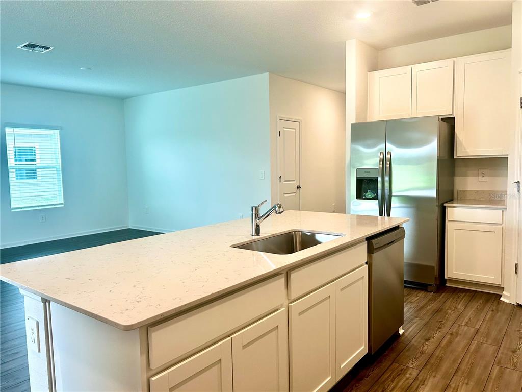 1103 Northwest 44th Court Road Ocala, FL 34482 - Photo 11 of 36 a kitchen with a sink and a refrigerator