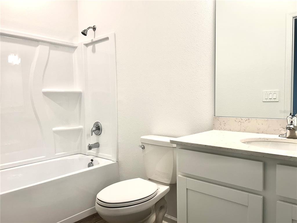 1103 Northwest 44th Court Road Ocala, FL 34482 - Photo 17 of 36 a bathroom with a sink a toilet and shower