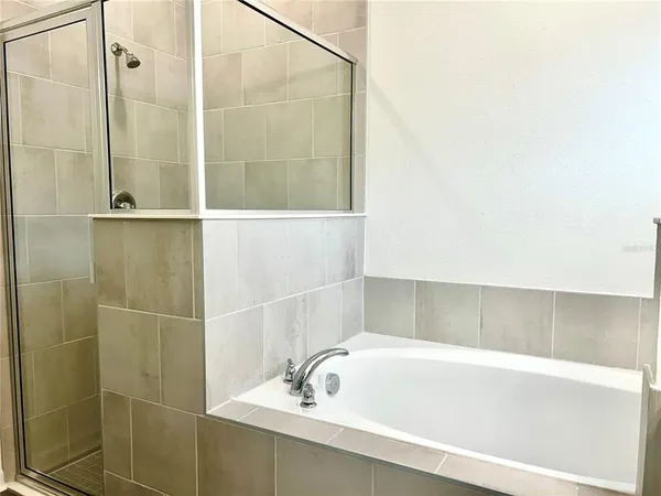 a bathroom with a bathtub and shower
