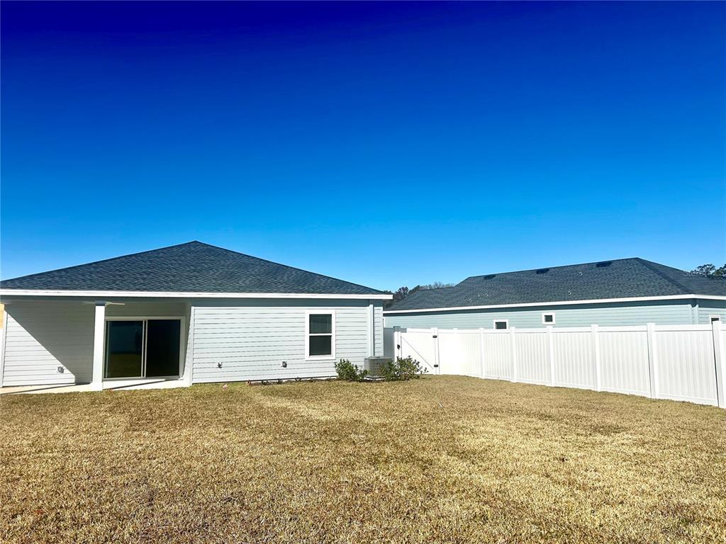 1103 Northwest 44th Court Road Ocala, FL 34482 - Photo 35 of 36 a view of an house with backyard space and a lake view