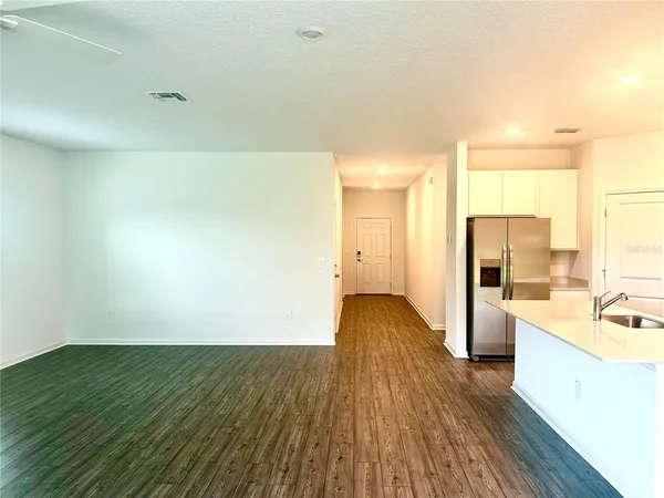 a view of a kitchen with a sink and a refrigerator