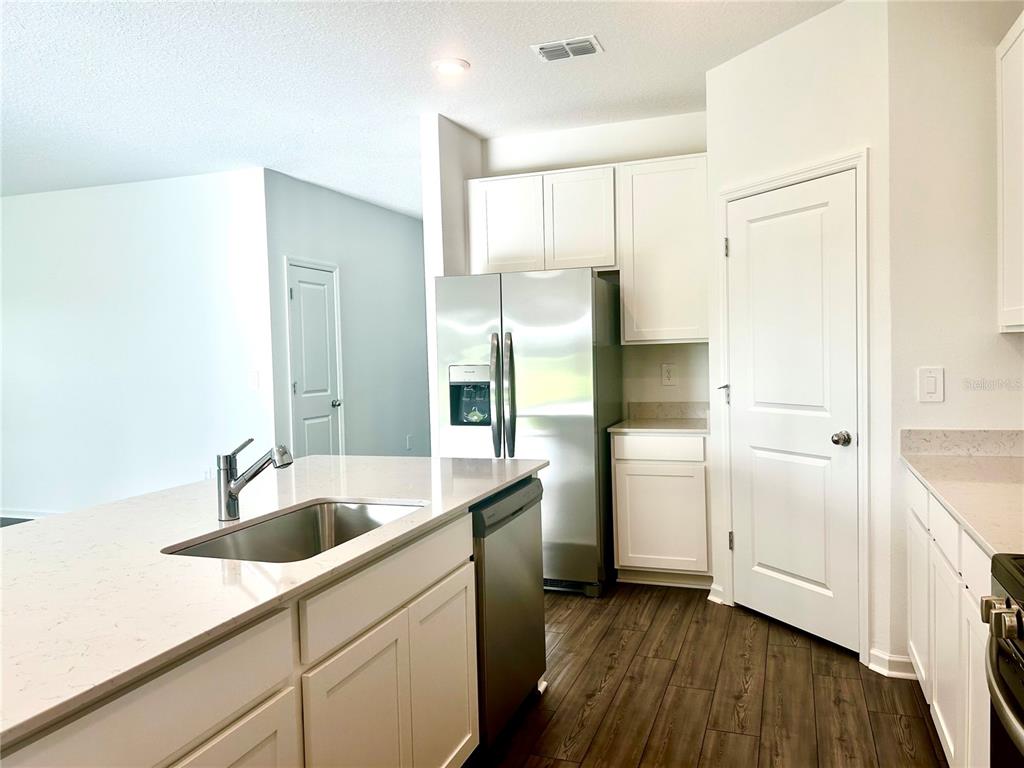 1103 Northwest 44th Court Road Ocala, FL 34482 - Photo 10 of 36 a kitchen with a sink and refrigerator