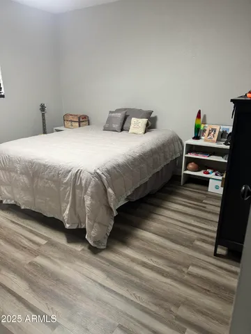a bedroom with two beds and a desk