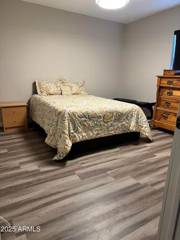 a bedroom with a bed and a dresser