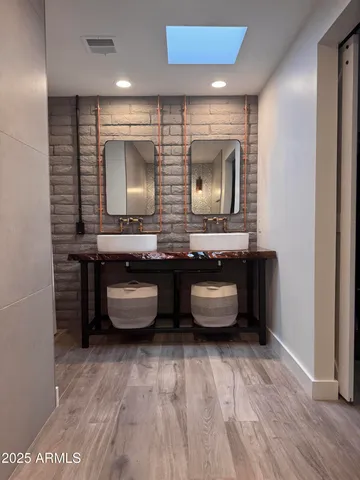 a bathroom with double vanity sink and a mirror